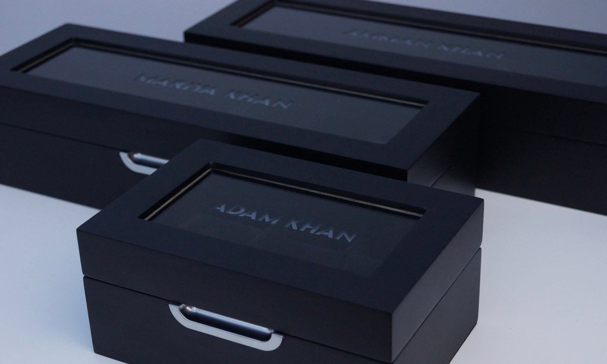 Three watch boxes that have been personalised via glass etching. Two of the watch boxes can hold 6 watches and the other can hold 3