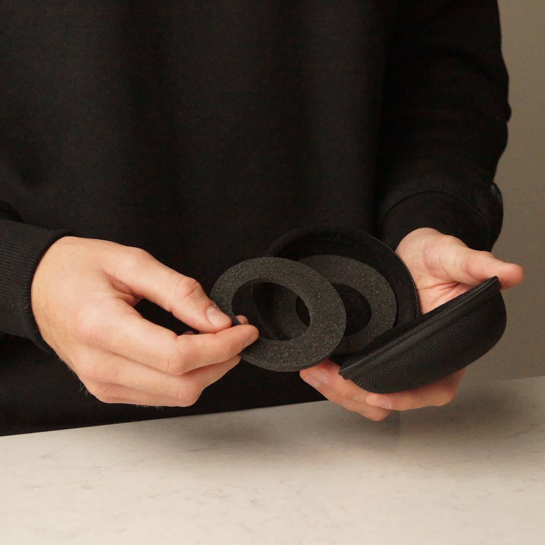 Front-angled lifestyle image of the Solo Explorer single watch case by Transform, with a man holding the protective foam inserts.