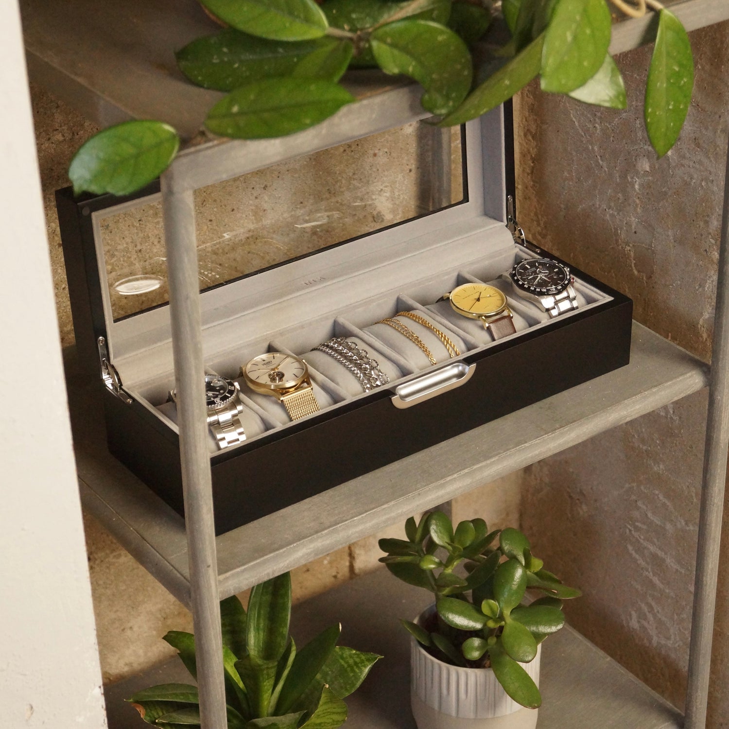 Men's valet tray presented with accessories on a dressing table