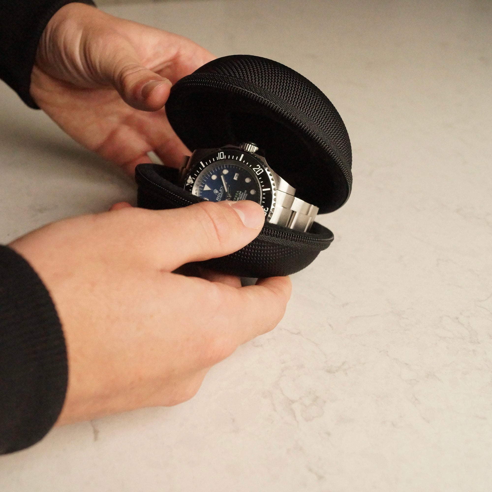 Image of the a man holding the Solo Explorer single watch travel case while it is open with a watch inside it