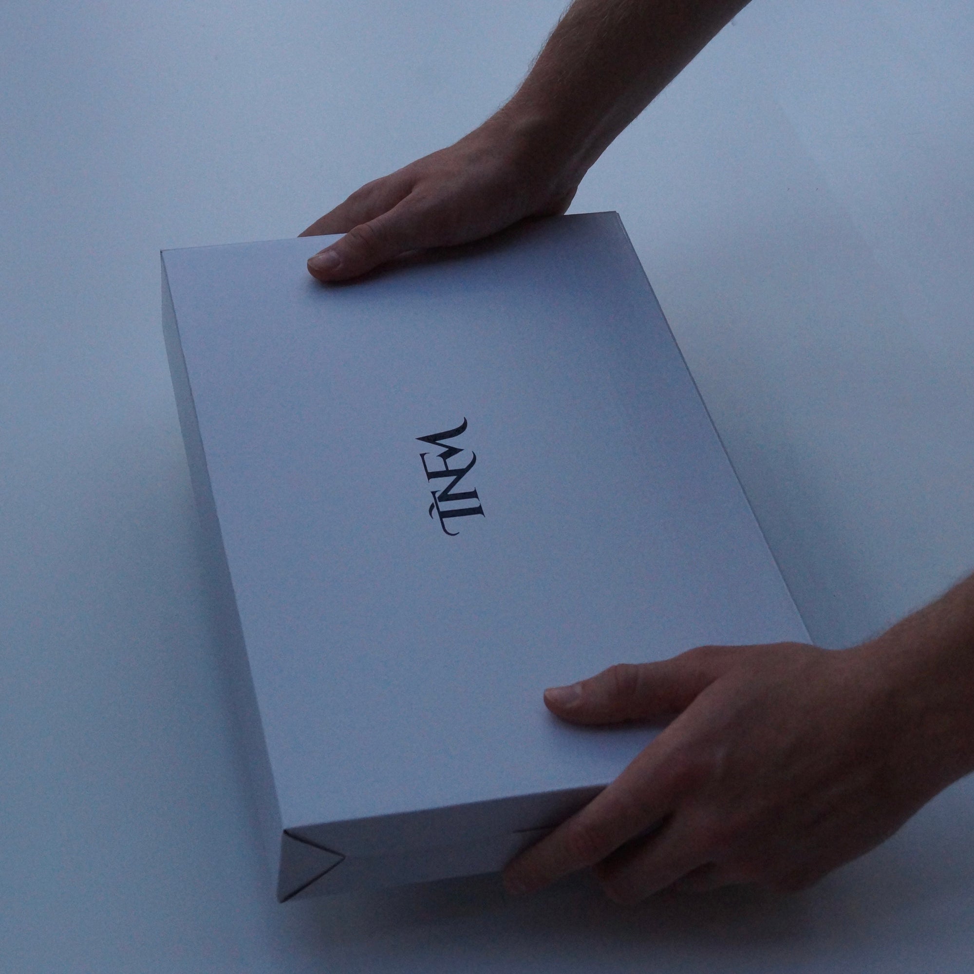 Image of a man holding a watch box that has been gift wrapped by Transform