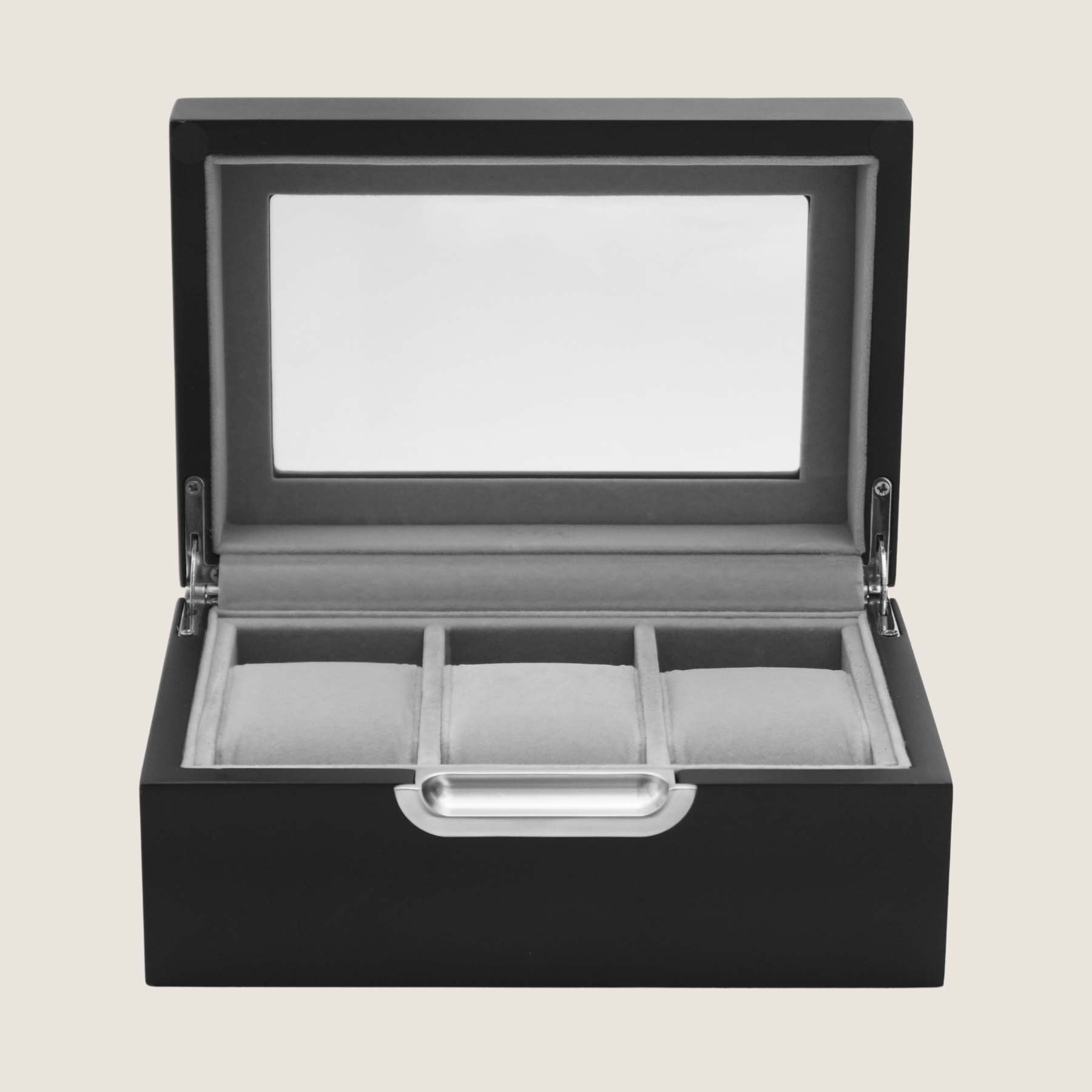 A black wooden watch box with an open hinged lid featuring a clear glass window and three interior watch slots, shown on a light beige background.