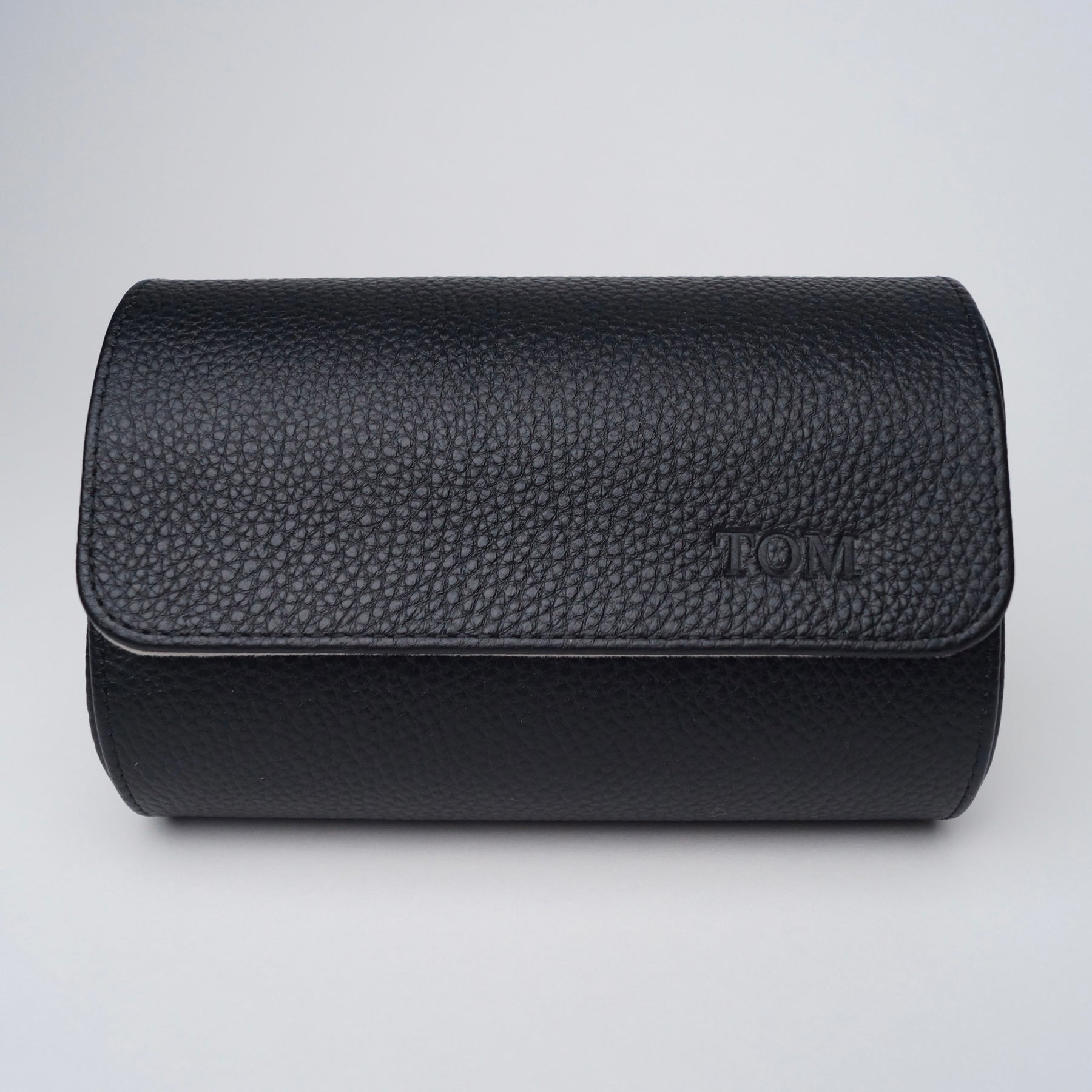 Black leather watch roll with 'Tom" engraved into the leather.