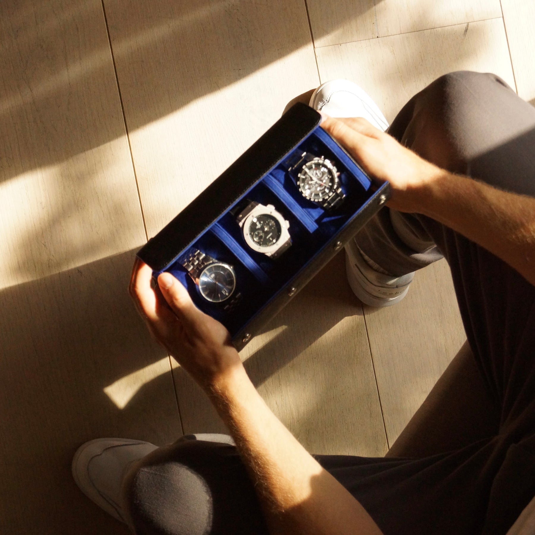 Bird’s eye view of 3 watches inside a leather watch roll from Transform.