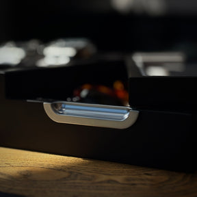 Close-up of an accessory tray on a wooden surface.