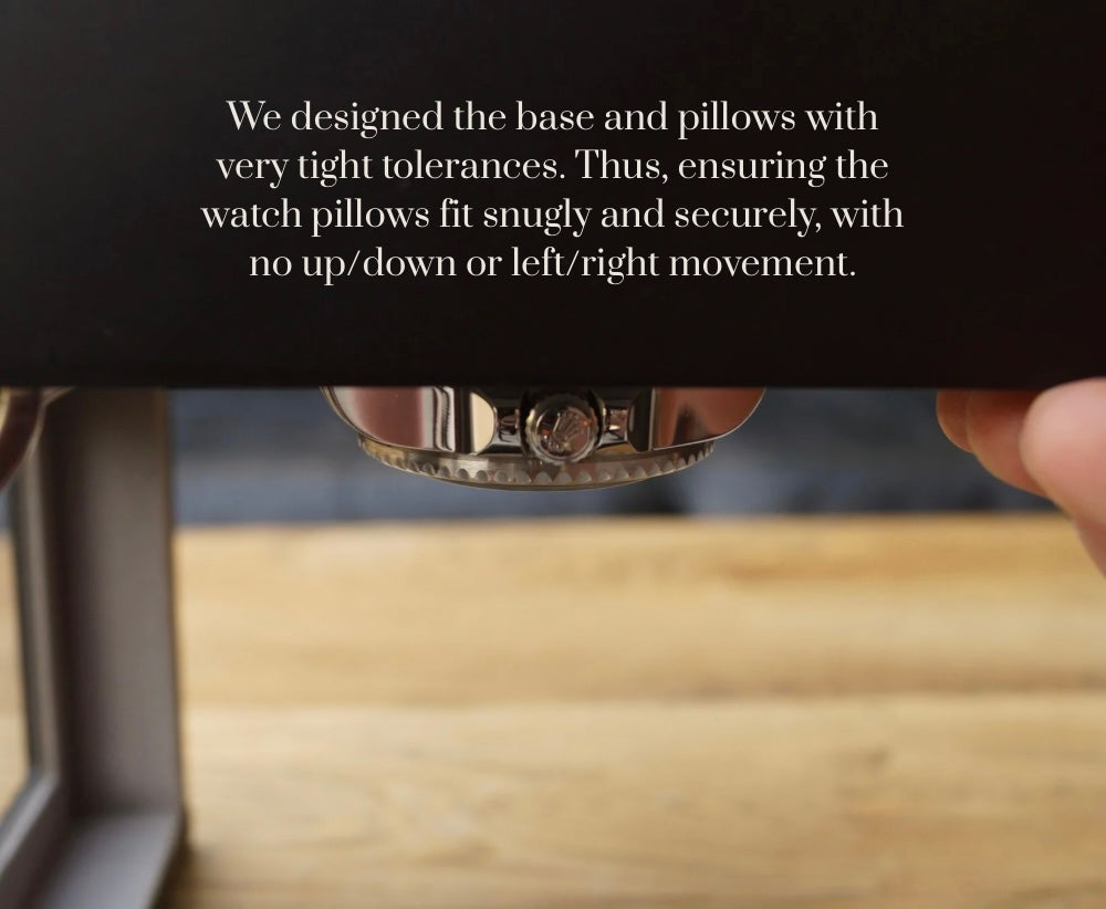 Composite feature image of the LDN Ill men's 3-slot black watch box by Transform, showing the organiser held upside down to demonstrate that the pillows fit snugly and securely. Text overlay reads 'Pillows That Fit' followed by 'We designed the base and pillows with very tight tolerances, thus ensuring the watch pillows fit snugly and securely, with no up/down or left/right movement.