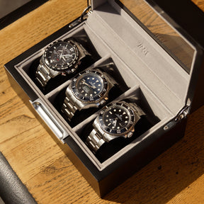 Bird’s-eye angled view of the LDN III men’s 3-slot grey watch box by Transform, shown open with three watches placed inside.