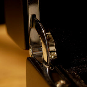 Close-up of the silver hinge detail on the LDN III men’s 3-slot black watch box by Transform.