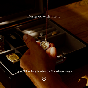 Close-up lifestyle image of the LDN IV men’s 4-slot black watch box by Transform, shown open as a man removes a necklace and holds it in his hand. Text overlay reads ‘Designed with intent’ and underneath ‘Scroll for key features and colourways.