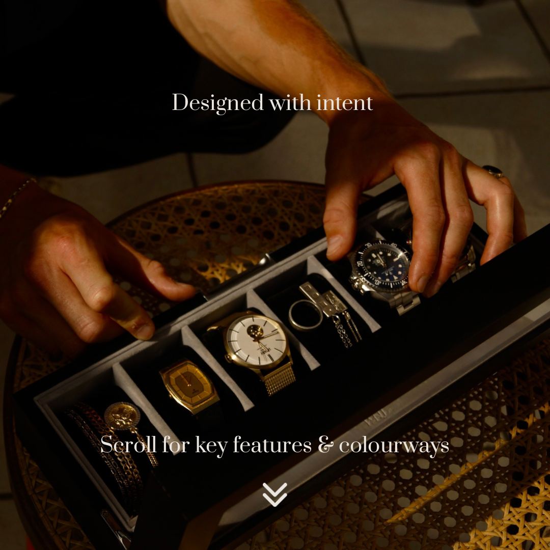 Lifestyle action image of the LDN VI men’s 6-slot black watch box by Transform, showing a man removing a watch and jewellery from the organiser. Text overlay reads ‘Designed with intent’ and underneath ‘Scroll for key features and colourways.