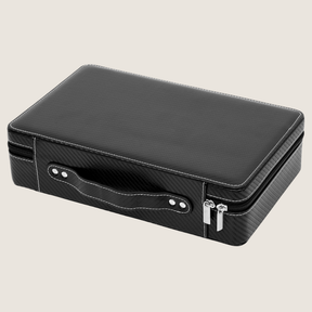 A black rectangular 10-slot watch case with a textured carbon fiber look, a handle and silver zipper pulls, shown on a light beige background.
