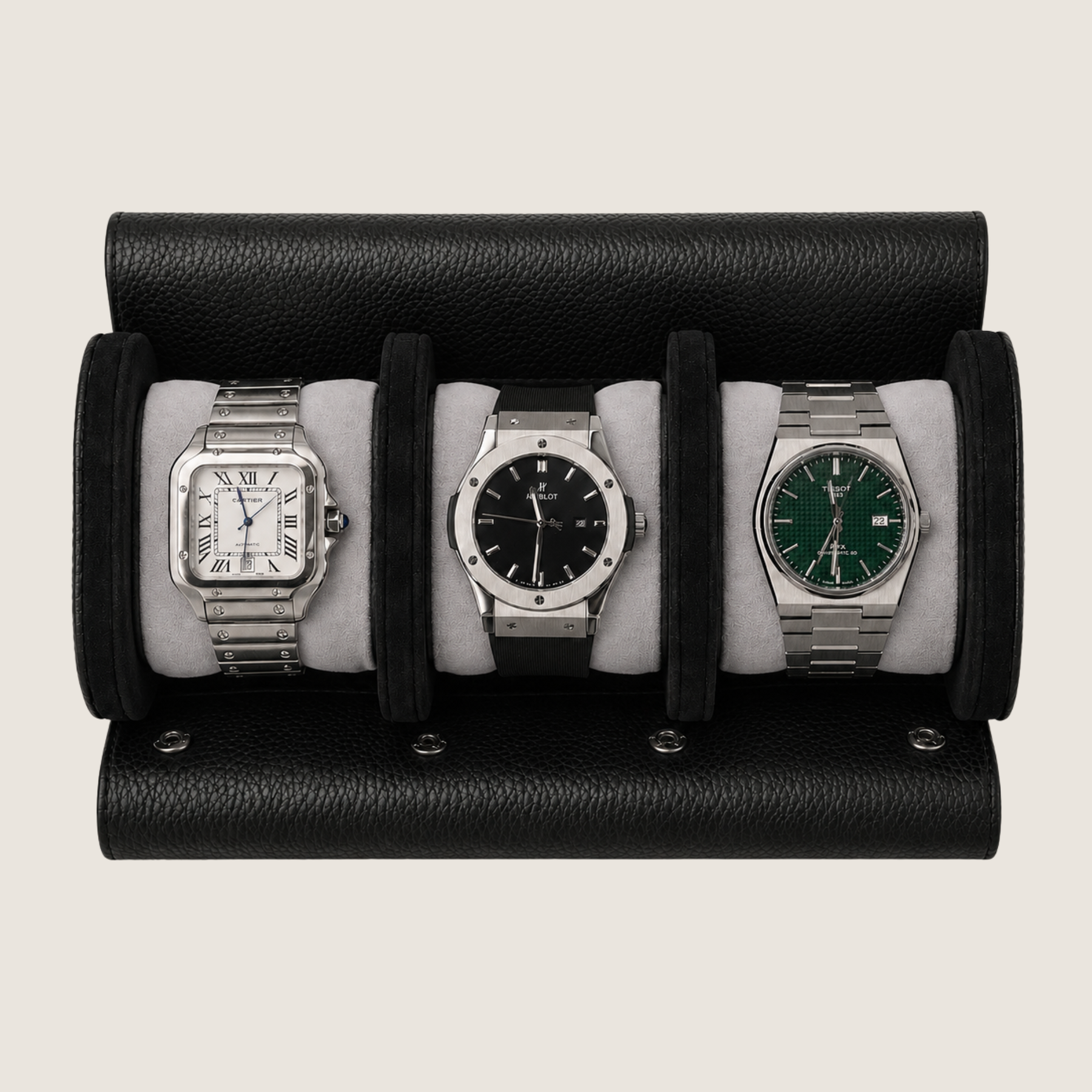 A black textured leather watch roll holding three wristwatches on light grey cushions, photographed against a plain light beige background.