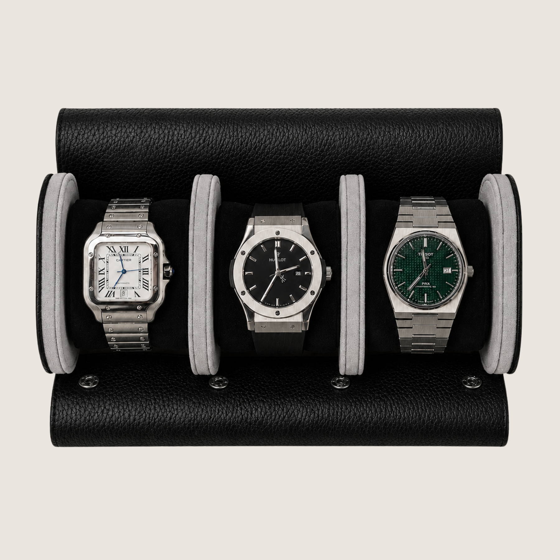 A black pebbled leather watch roll holding three wristwatches side by side on a light beige background.