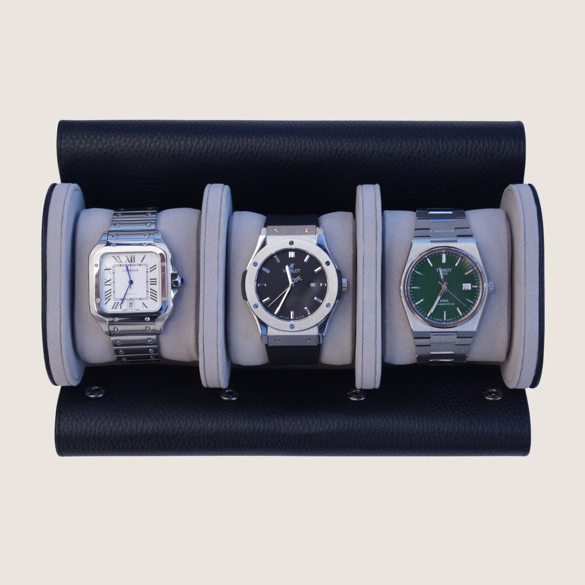 Three watches inside a leather watch roll with beige background.