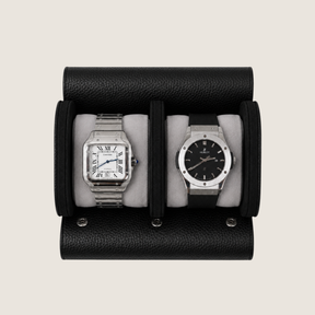 A black pebbled leather watch roll with two watches displayed side by side.